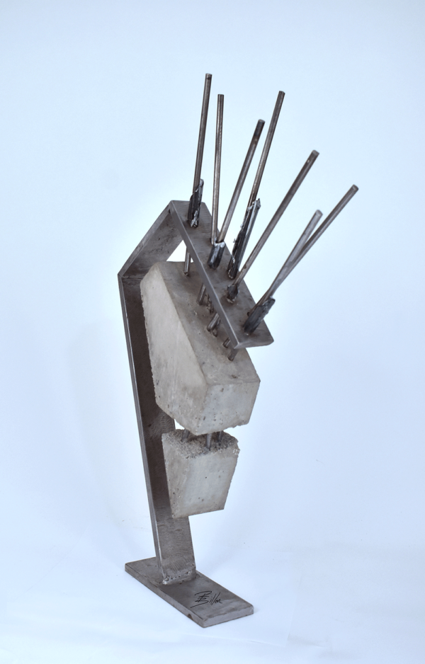 Abstract Sculpture of steel arm holding triangulated concrete block suspended by steel rods.