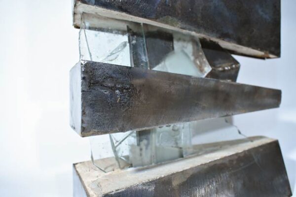 Steel skin is filled with concrete. The three separate segments sharing a universal spine of glass.