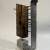 table-top sculpture: steel, concrete, and wood.