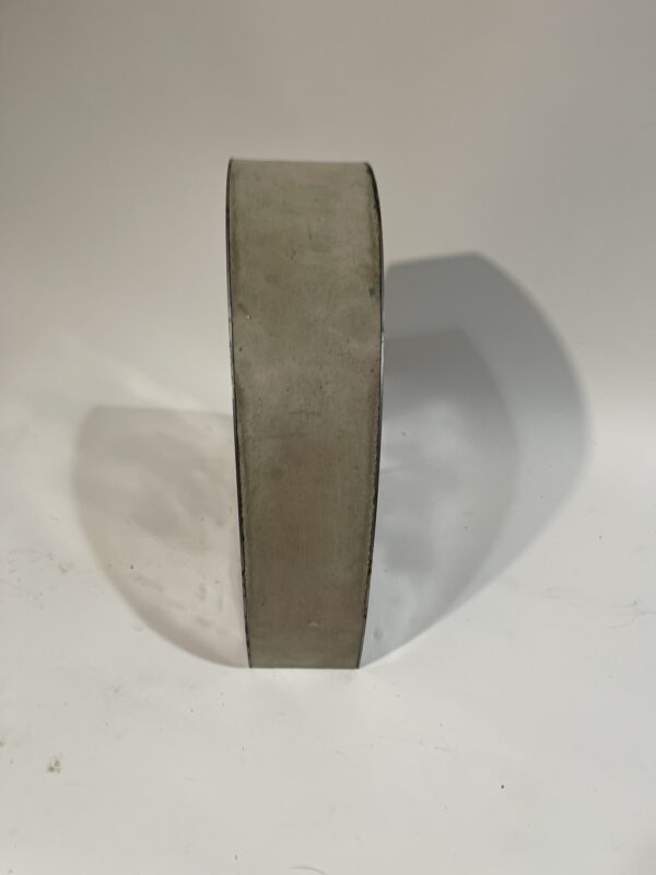 Abstract concrete and steel sculpture with a geometric shape and black flower silhouettes on each side.