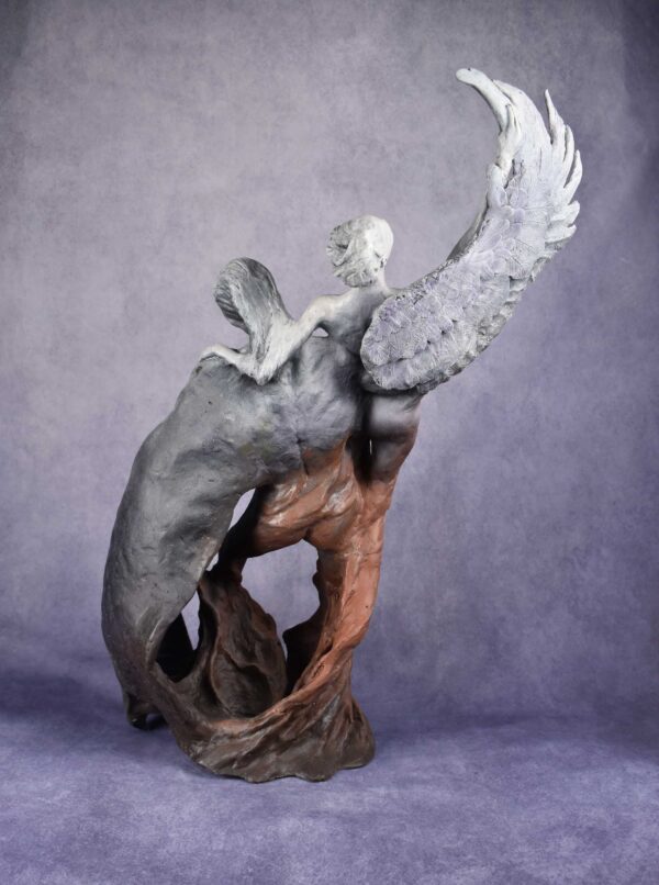 Rear view: figurative sculpture of a man and woman rising from a swirl. man has a devil wing, woman has an angel wing